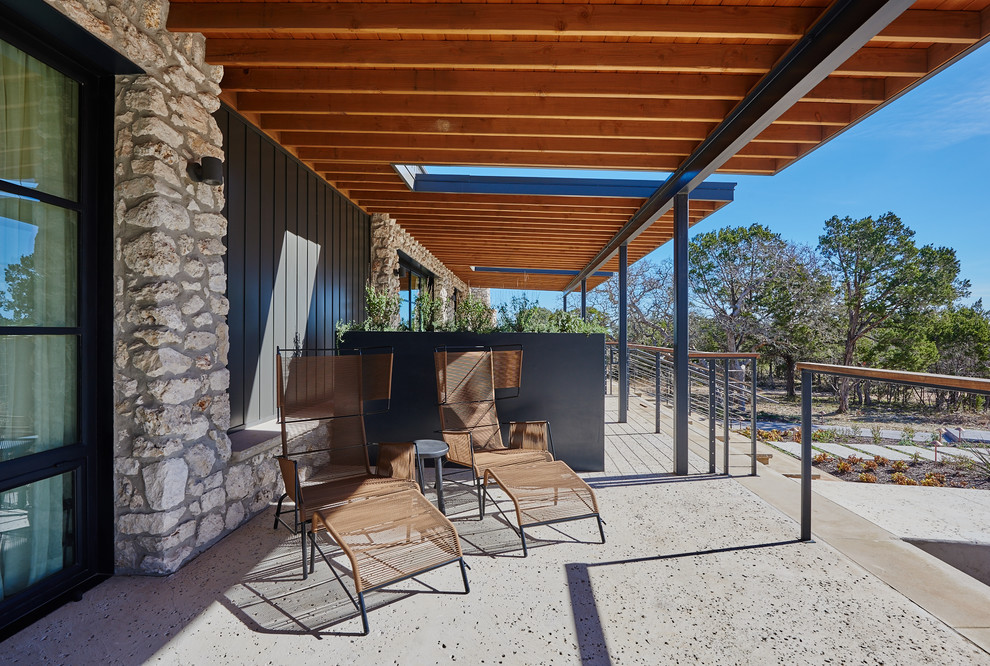 Foto di un patio o portico minimalista di medie dimensioni e nel cortile laterale con pavimentazioni in pietra naturale e nessuna copertura