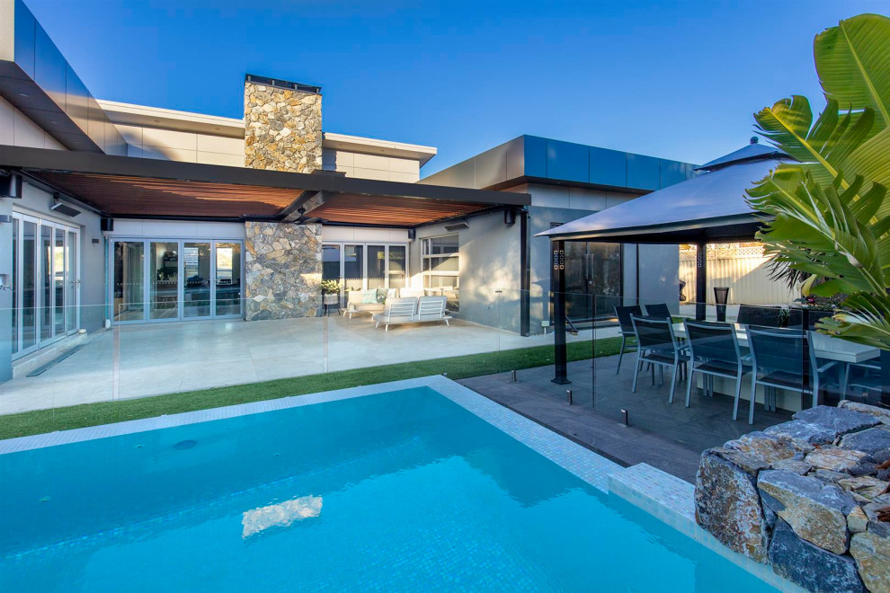 Inspiration for an expansive contemporary back patio in Sydney with an outdoor kitchen.