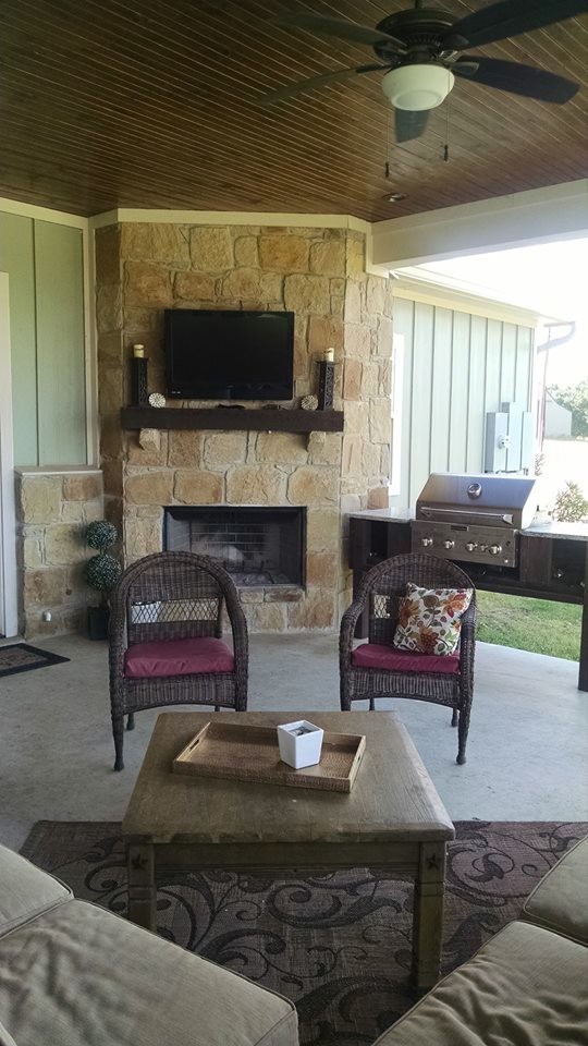 Photo of a medium sized classic back patio in Austin with an outdoor kitchen, concrete slabs and a roof extension.