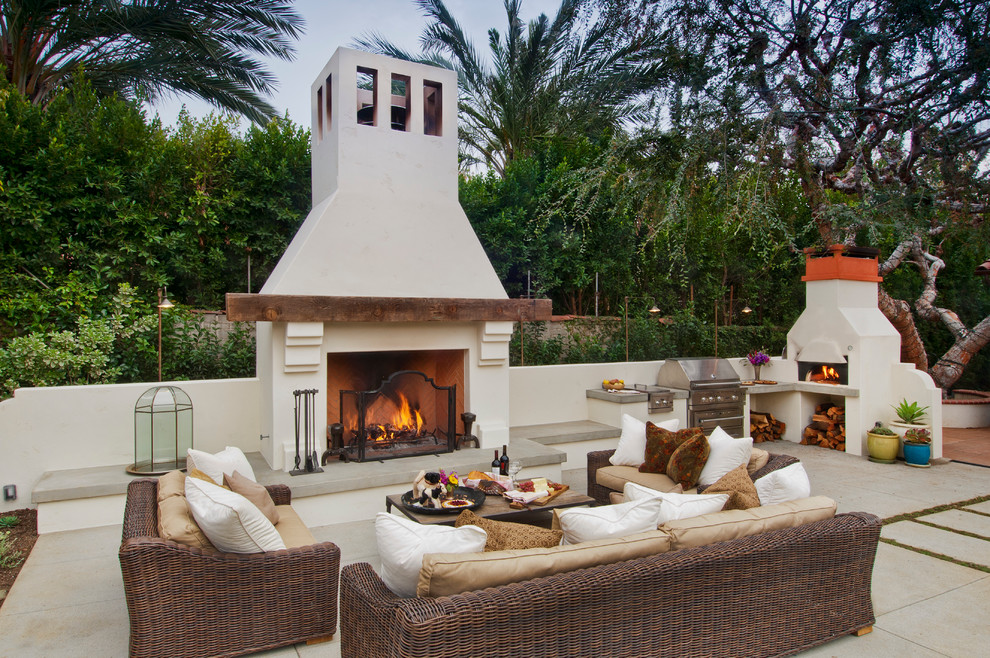 Patio kitchen - large traditional backyard concrete paver patio kitchen idea in Orange County