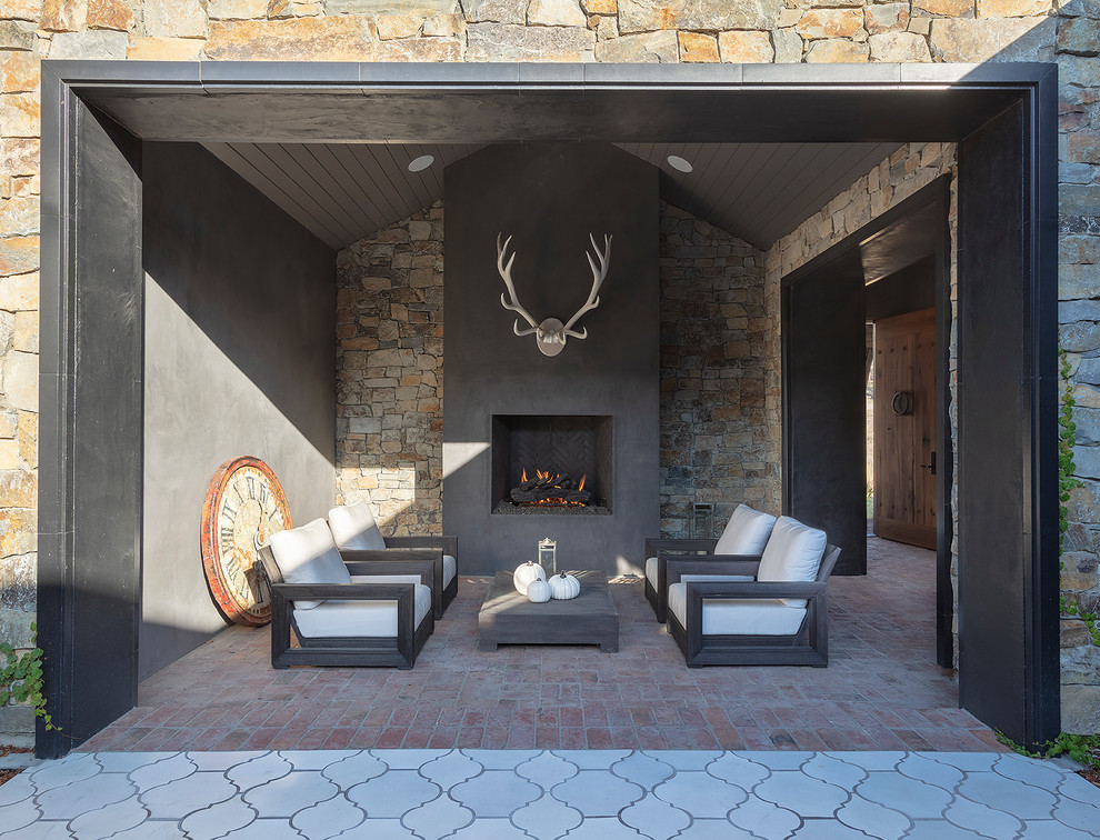 Inspiration for a rustic brick patio remodel in San Francisco with a fireplace and a roof extension