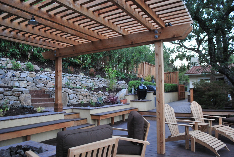 Example of a mid-sized tuscan backyard patio kitchen design in San Francisco with decking and a pergola