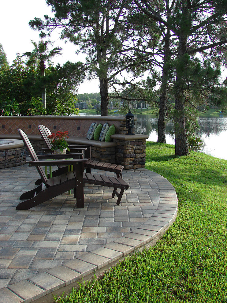 Medium sized traditional back patio in Orlando with concrete paving and no cover.