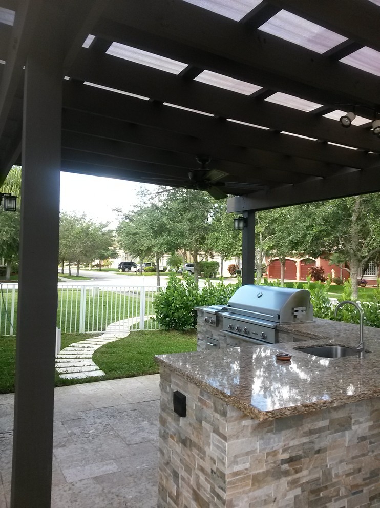 Design ideas for a medium sized traditional back patio in Miami with an outdoor kitchen, concrete paving and a pergola.