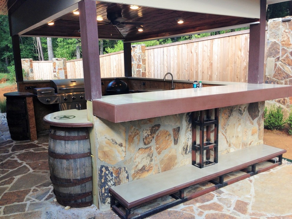This is an example of a medium sized rustic back patio in Austin with a fire feature, natural stone paving and a roof extension.