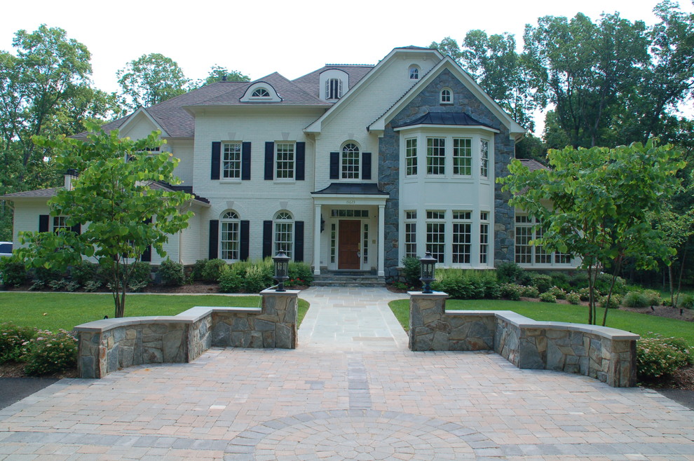This is an example of a large classic front patio in Baltimore with natural stone paving and no cover.