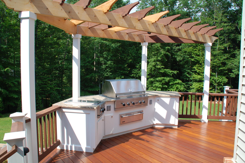 Réalisation d'une terrasse en bois arrière tradition de taille moyenne avec une cuisine d'été et une pergola.