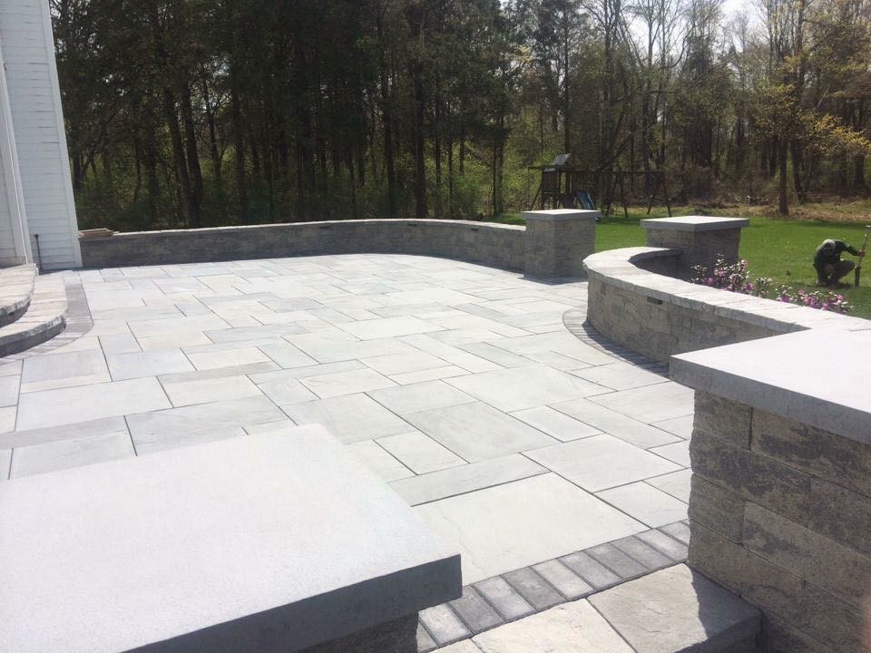Patio - mid-sized traditional backyard tile patio idea in New York with no cover