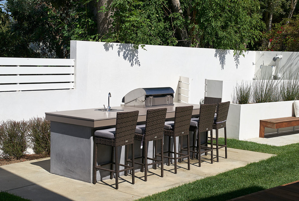 Photo of a contemporary back patio in Los Angeles with concrete slabs, no cover and a bar area.