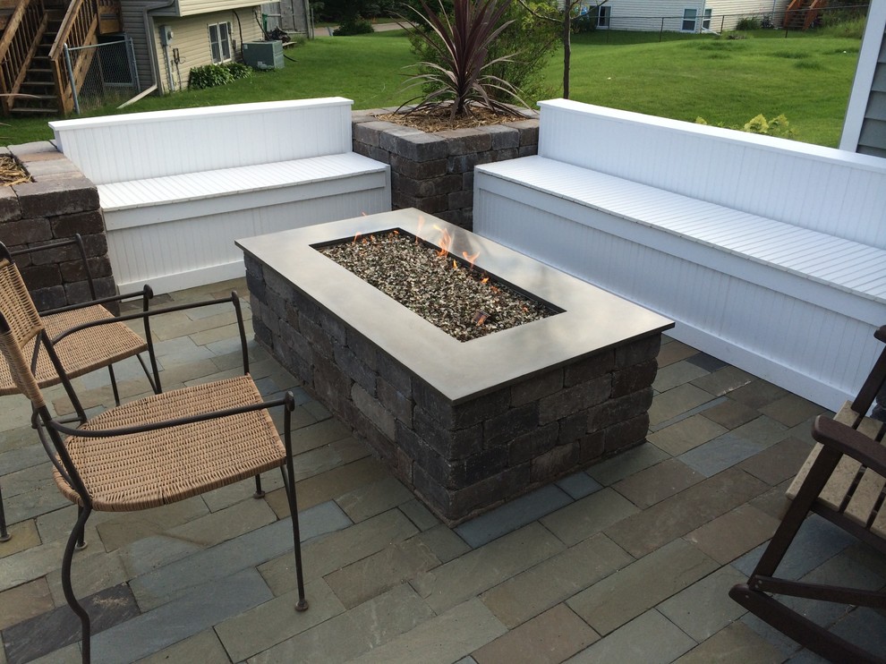 Medium sized classic back patio in Minneapolis with a fire feature, natural stone paving and a gazebo.