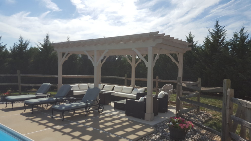 Inspiration for a mid-sized transitional backyard concrete patio remodel in Philadelphia with a pergola