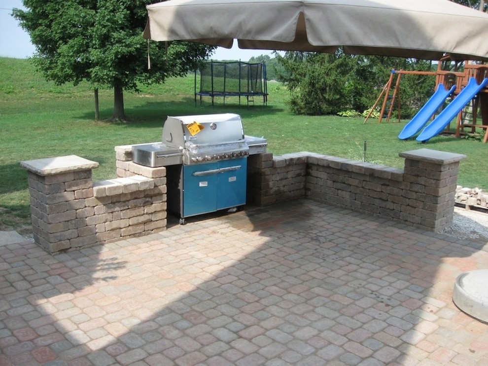 Large classic back patio in Columbus with an outdoor kitchen, brick paving and no cover.