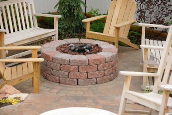 Example of a mid-sized classic backyard brick patio design in Salt Lake City with a fire pit