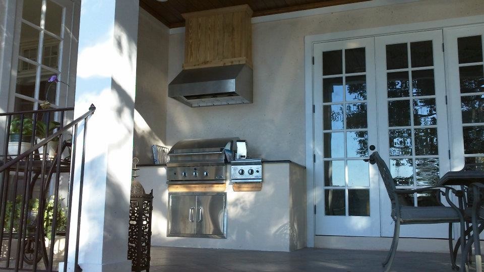 Inspiration for a medium sized traditional back patio in Orlando with an outdoor kitchen, concrete paving and a roof extension.