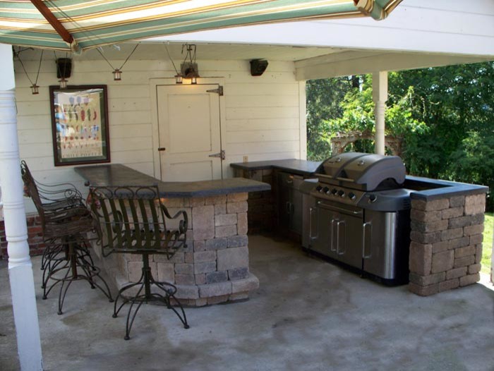 Inspiration for a large timeless backyard concrete patio kitchen remodel in Columbus with a roof extension