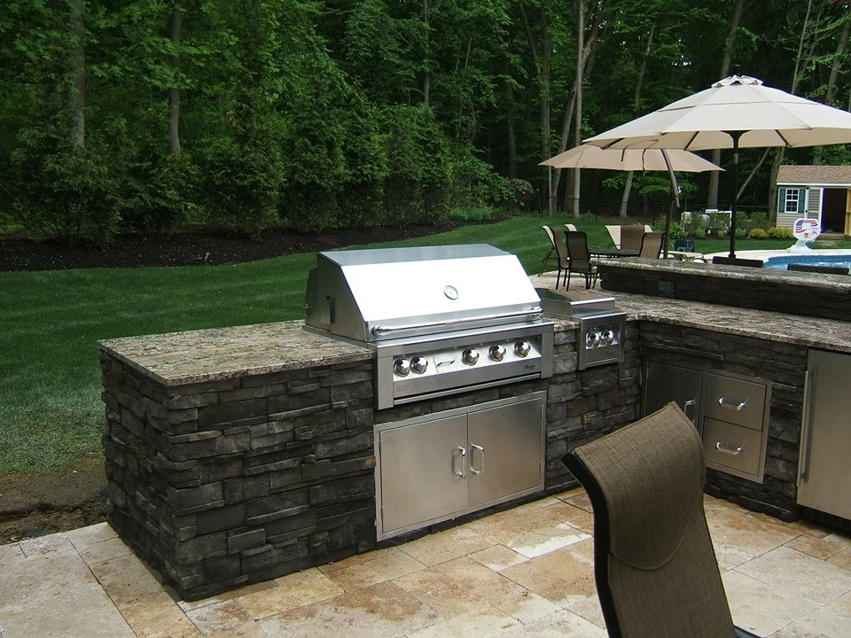 Inspiration for a medium sized traditional back patio in New York with an outdoor kitchen, tiled flooring and no cover.