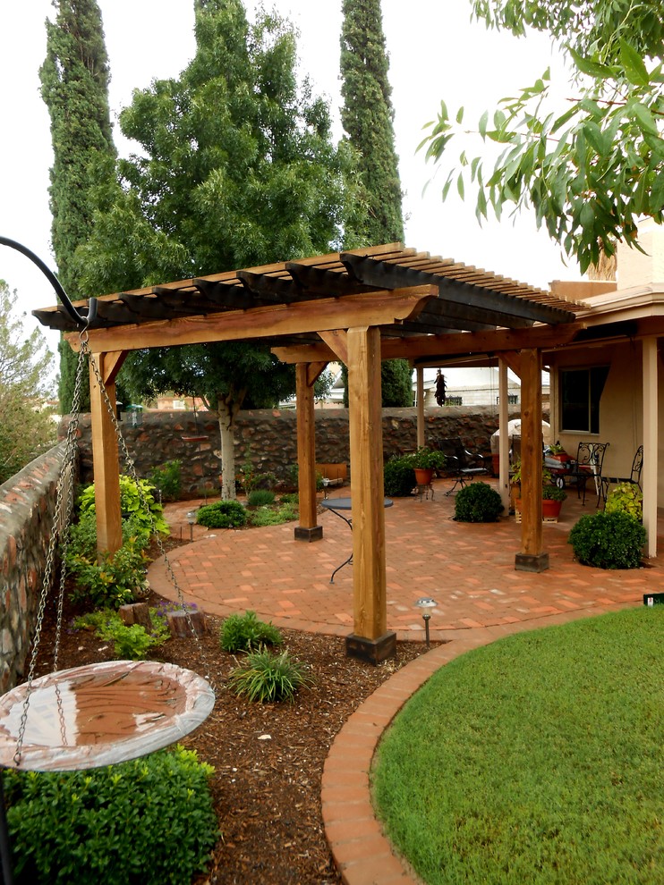 Inspiration for a classic back patio in Austin with brick paving and a pergola.