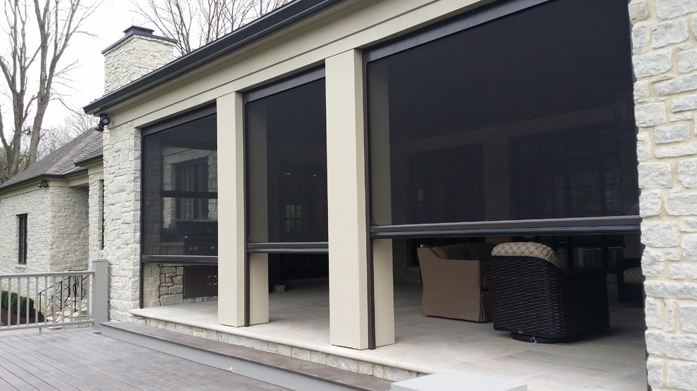Large classic back patio in Louisville with concrete paving and a roof extension.