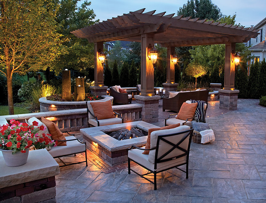 Example of a large classic backyard stamped concrete patio design in Phoenix with a fire pit and a pergola