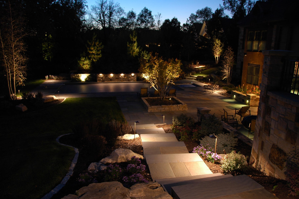 Design ideas for a medium sized traditional back patio in Minneapolis with natural stone paving and no cover.