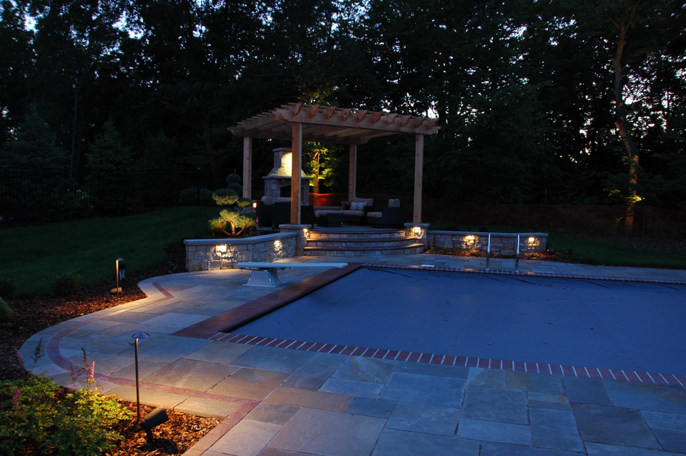 Inspiration for a large timeless backyard concrete paver patio remodel in Minneapolis with a fire pit and a pergola