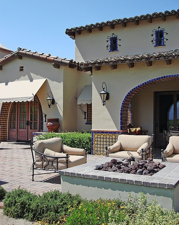 This is an example of a medium sized mediterranean back patio in Los Angeles with an outdoor kitchen, no cover and brick paving.