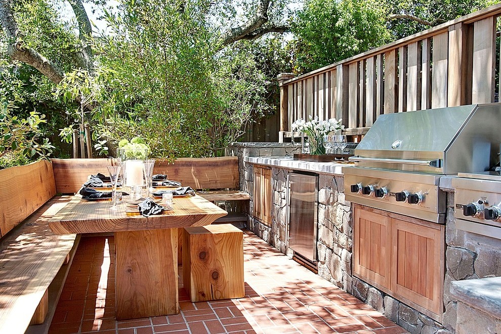 Medium sized rustic back patio in Los Angeles with an outdoor kitchen, brick paving and no cover.