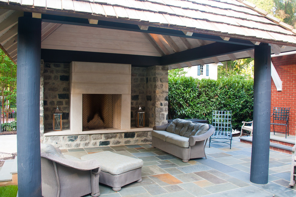 Esempio di un patio o portico di medie dimensioni e dietro casa con un focolare, graniglia di granito e un gazebo o capanno