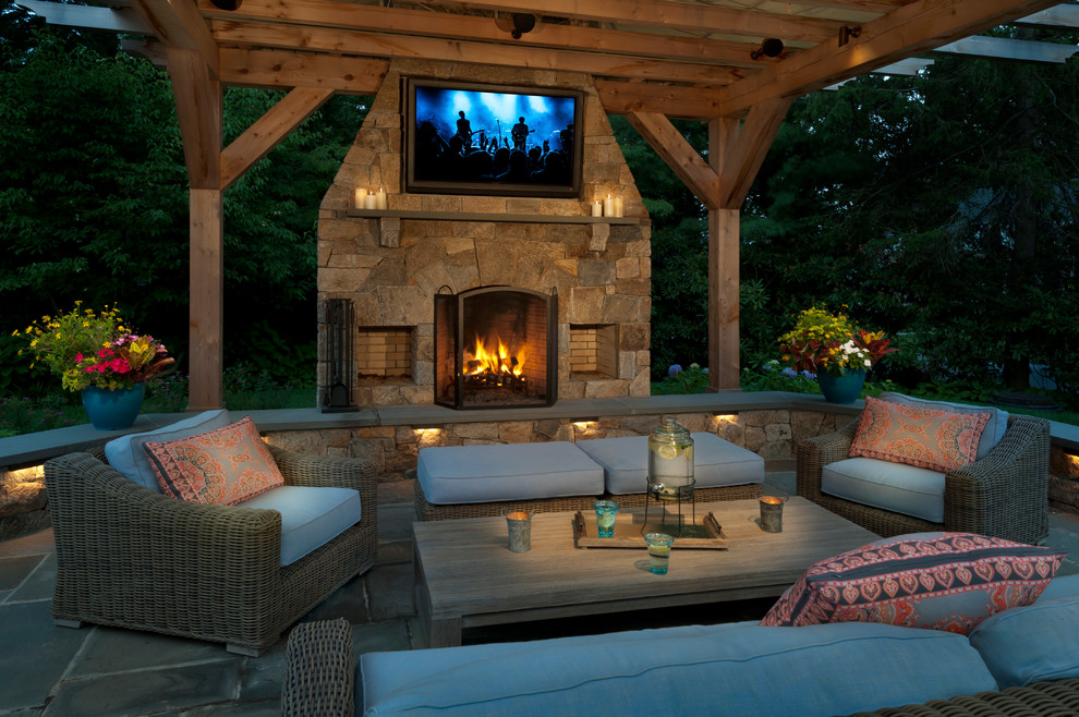 Photo of a contemporary patio in New York with a fireplace.