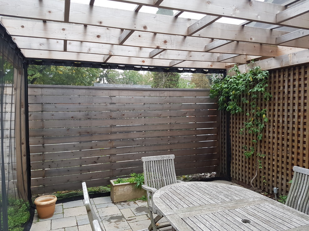 Outdoor Curtains in an Etobicoke backyard Pergola Traditional Patio