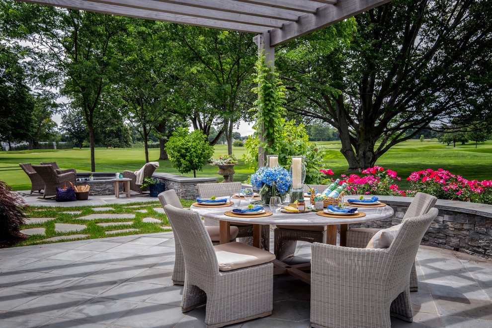 Inspiration for a traditional back patio in Providence with concrete paving and a pergola.