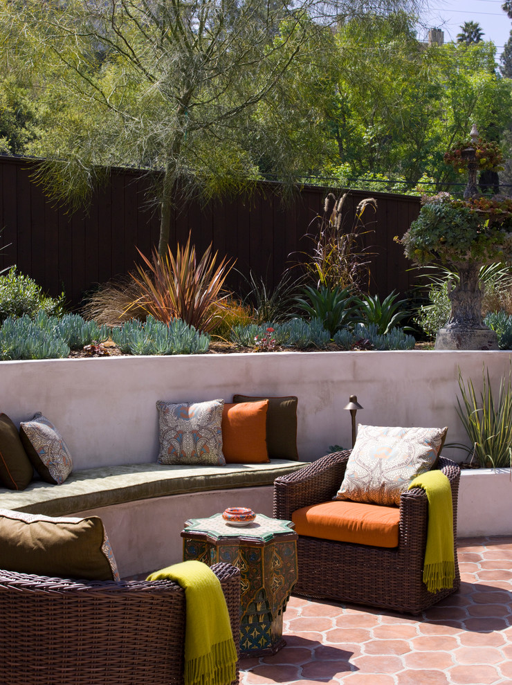 Example of a tuscan tile patio design in Los Angeles with no cover