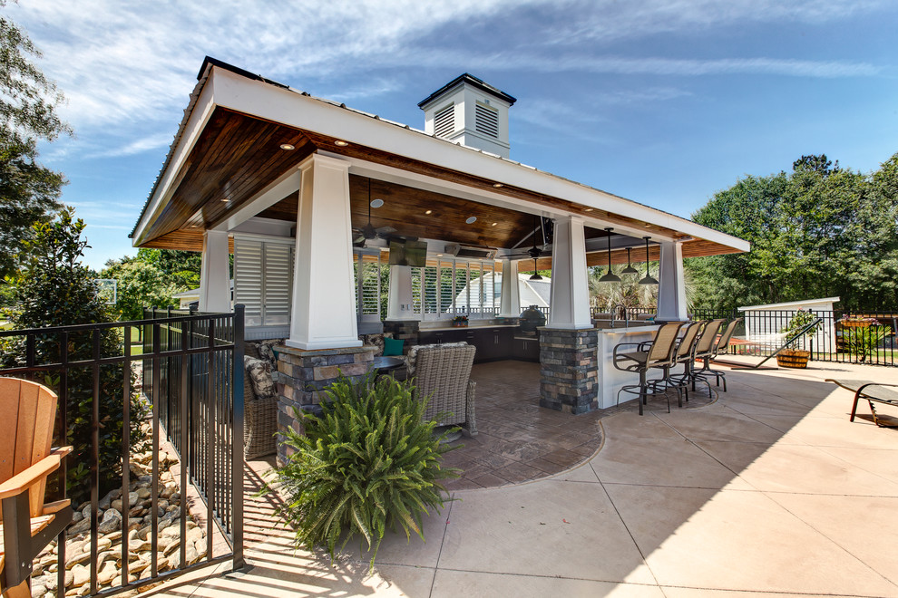 Design ideas for a large beach style back patio in Raleigh with an outdoor kitchen, stamped concrete and a gazebo.