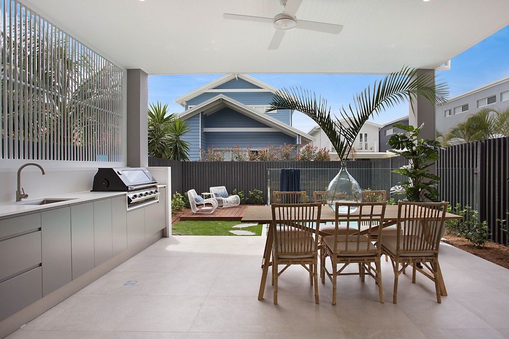 Inspiration for a contemporary backyard concrete paver patio kitchen remodel in Gold Coast - Tweed with a roof extension