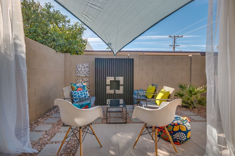 Inspiration for a medium sized midcentury back patio in Phoenix with concrete paving and no cover.