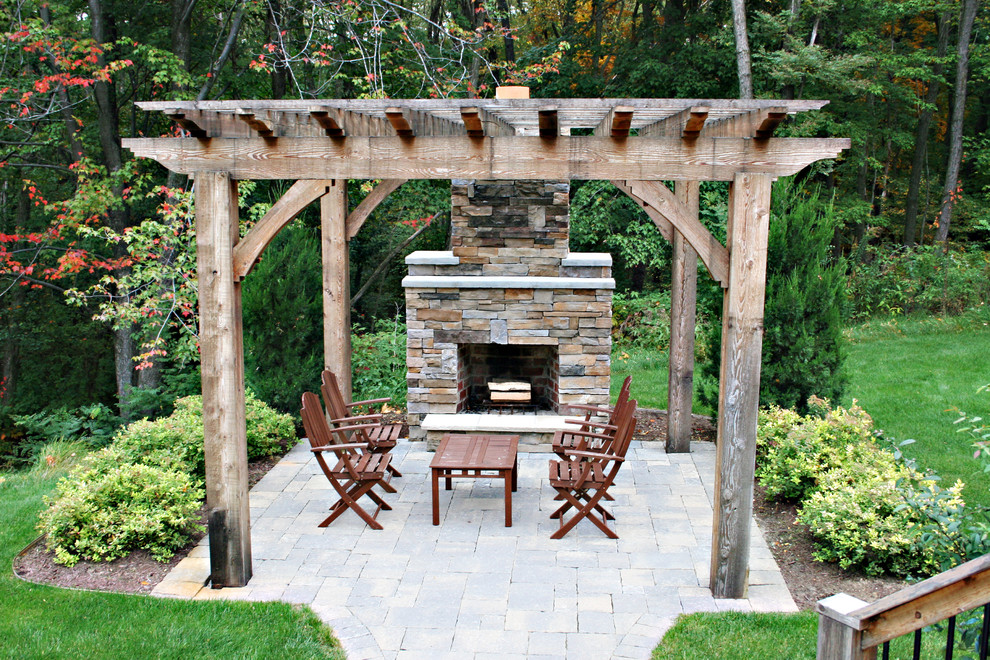 Photo of a traditional patio in Grand Rapids with a fire feature and a pergola.