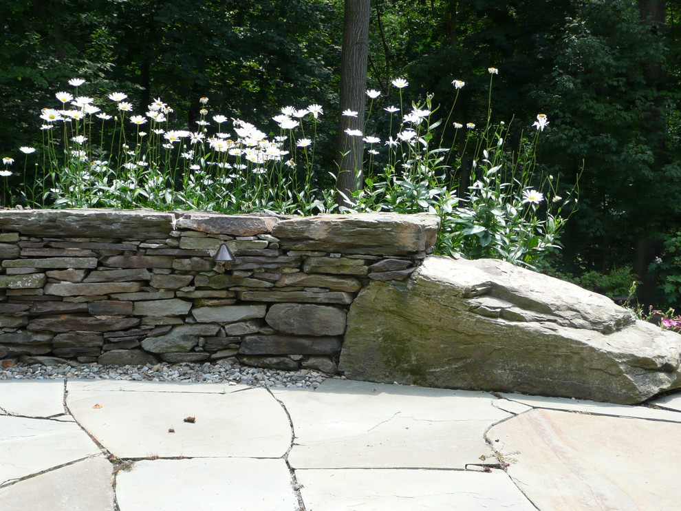Outdoor flagstone patio with dry stack seat wall Rustic Patio