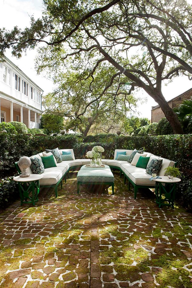 Elegant brick patio photo in Raleigh with no cover