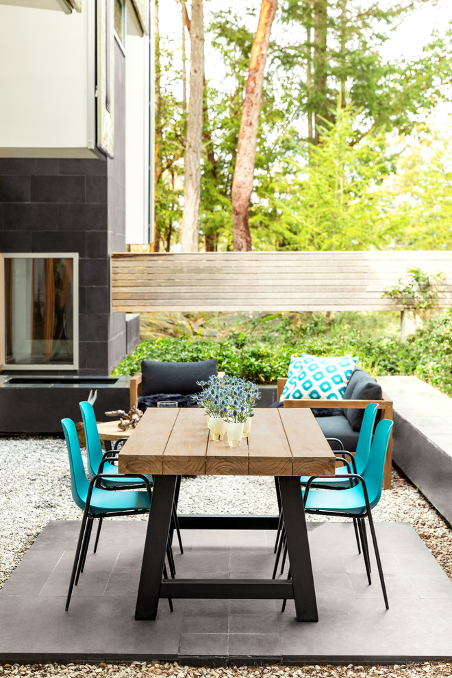 Immagine di un patio o portico contemporaneo dietro casa con piastrelle