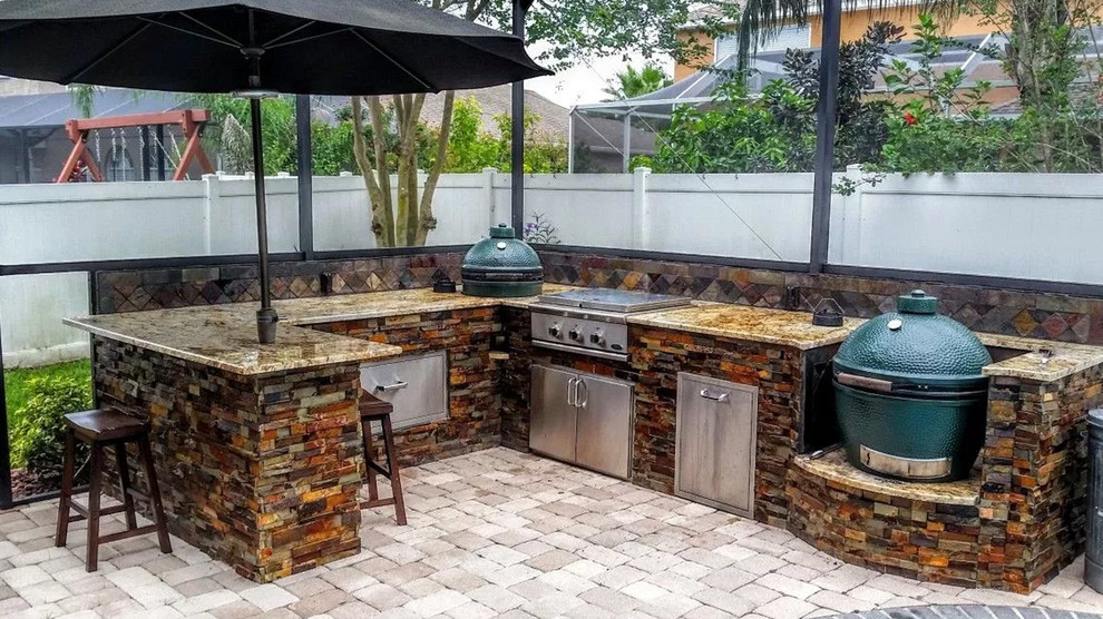 Inspiration for a mid-sized transitional backyard brick patio kitchen remodel with no cover