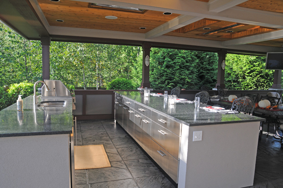 Large classic back patio in Seattle with an outdoor kitchen, concrete paving and a gazebo.