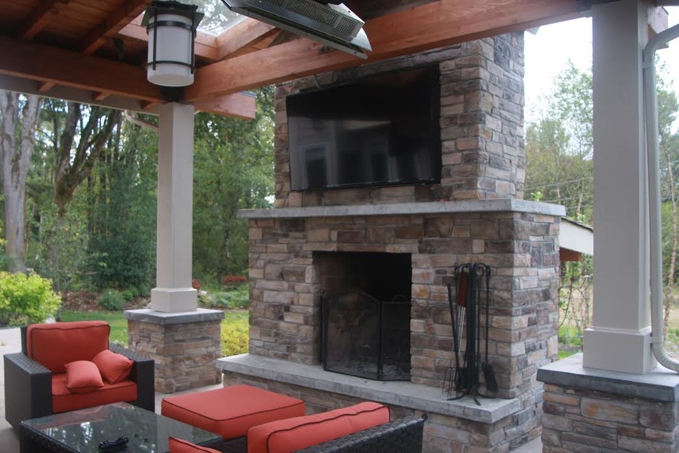 Example of a large transitional backyard concrete patio kitchen design in Seattle with a gazebo