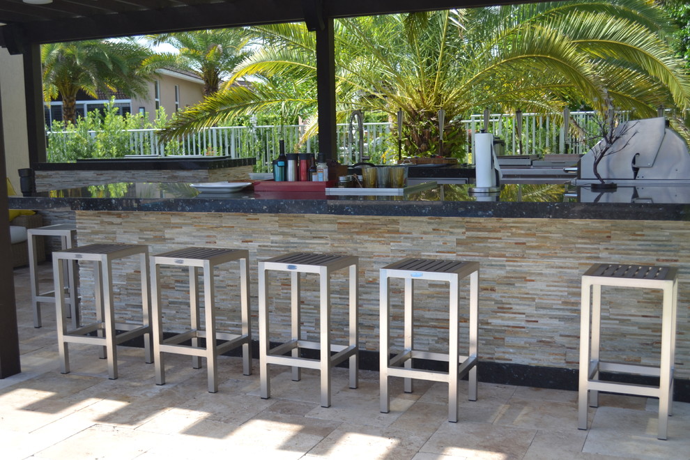Foto di un ampio patio o portico mediterraneo dietro casa con pavimentazioni in pietra naturale e una pergola