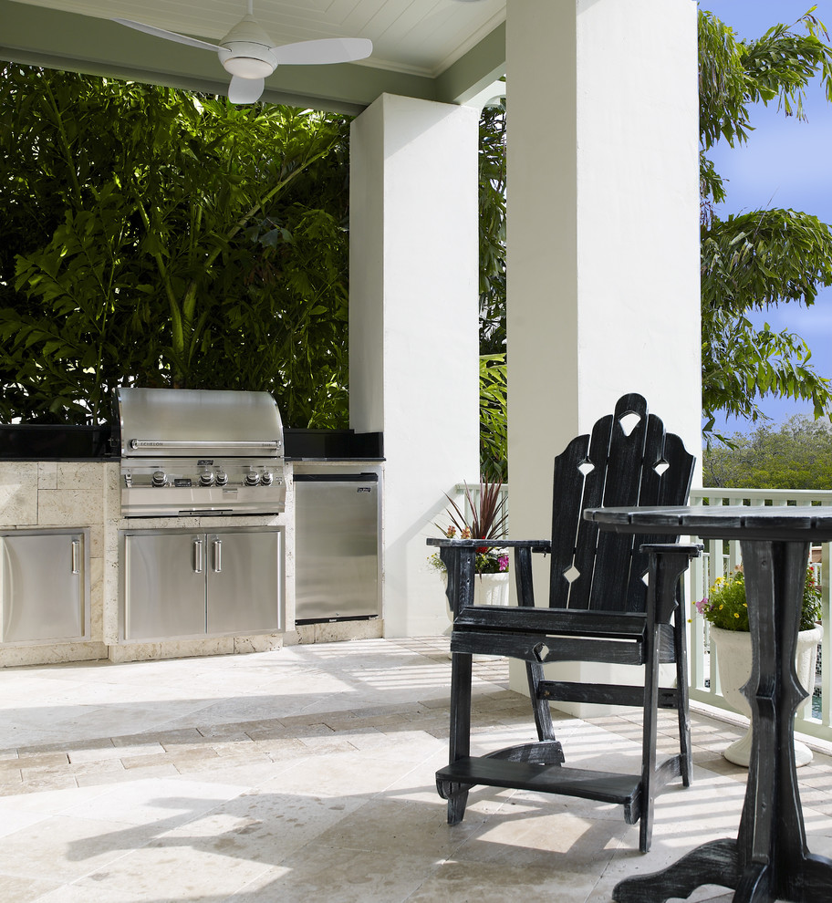 Inspiration for a mid-sized tropical backyard stamped concrete patio kitchen remodel in Tampa with a roof extension