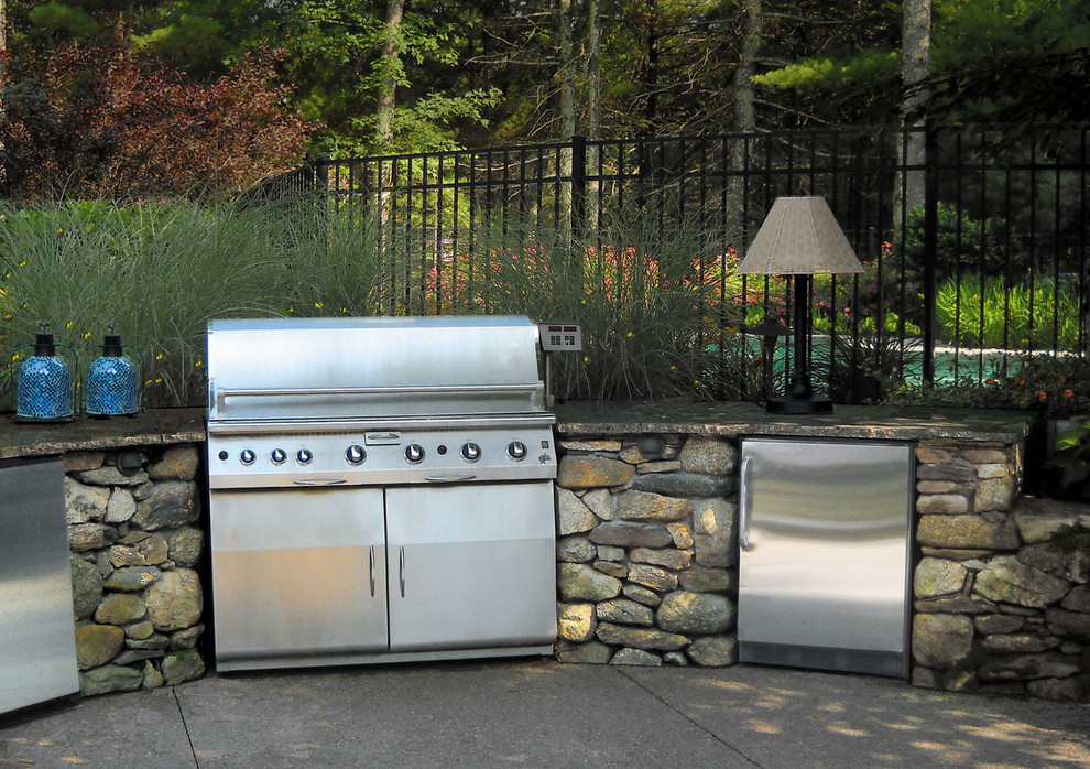 Large contemporary back patio in Providence with an outdoor kitchen, concrete paving and no cover.
