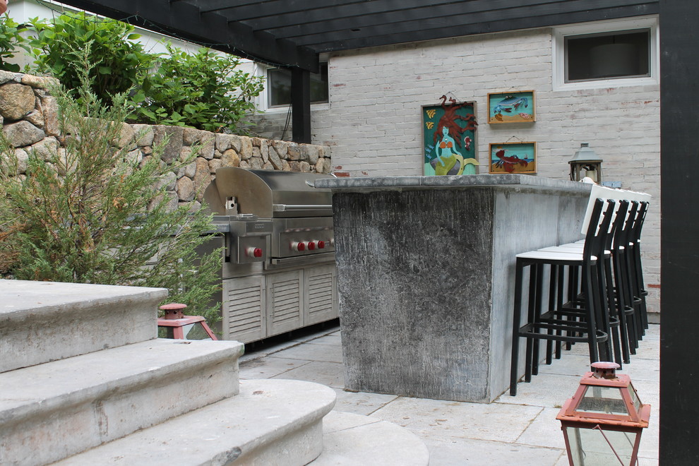 Inspiration for a large eclectic back patio in Boston with an outdoor kitchen, concrete paving and a pergola.