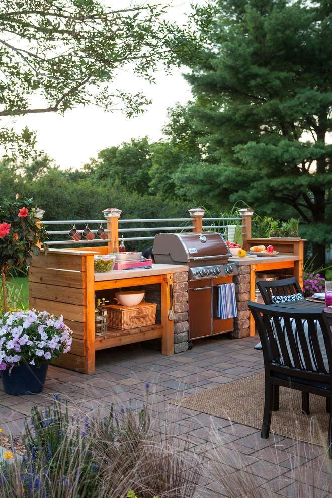 Patio kitchen - small industrial backyard brick patio kitchen idea in Other