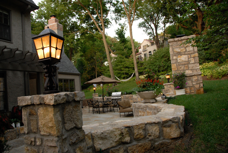 Inspiration for a medium sized traditional back patio in Kansas City with a fire feature, natural stone paving and no cover.