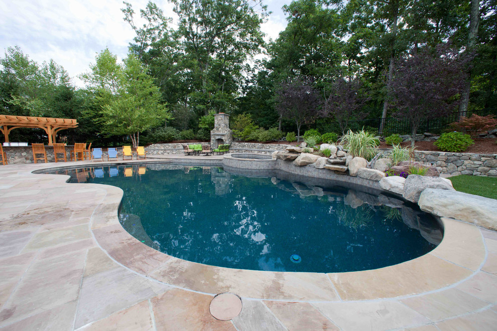 Inspiration for a mid-sized timeless backyard stone pool remodel in Boston