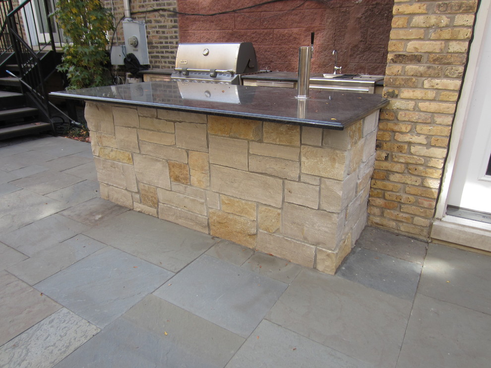 Photo of a medium sized traditional back patio in Chicago with stamped concrete and no cover.